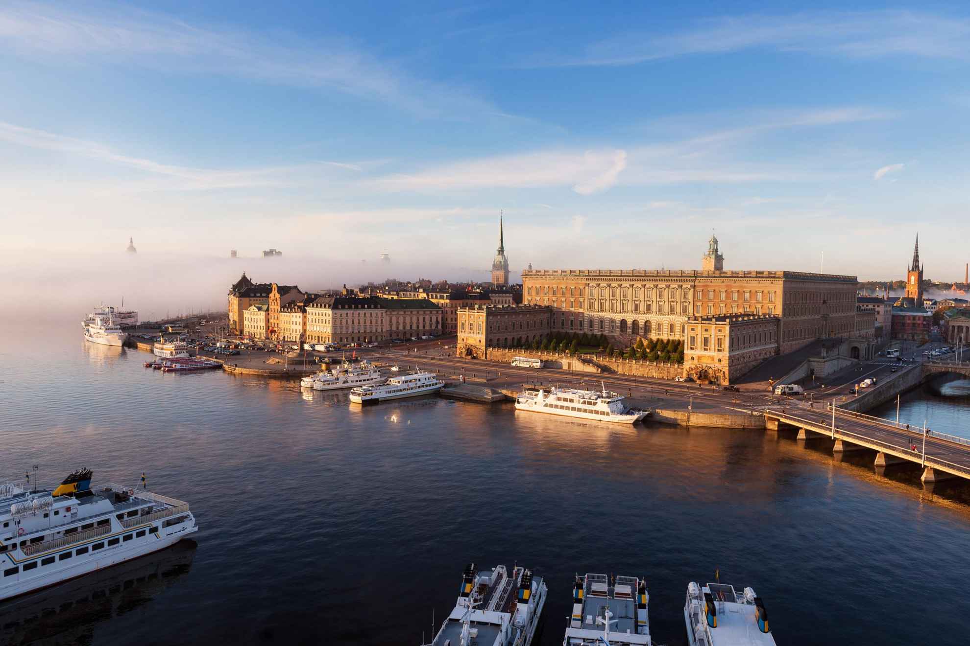 Aerial view over the Royal Palace and other buildings in Stockholm city. Boats are moored along the harbour.