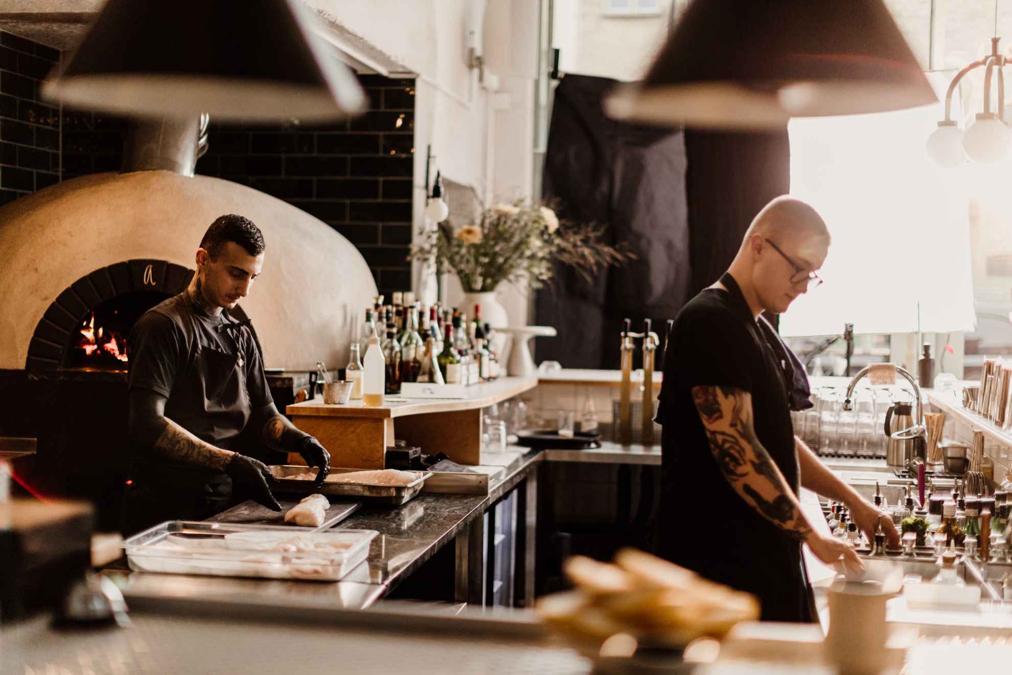 Two chefs working in a restaurant kitchen.