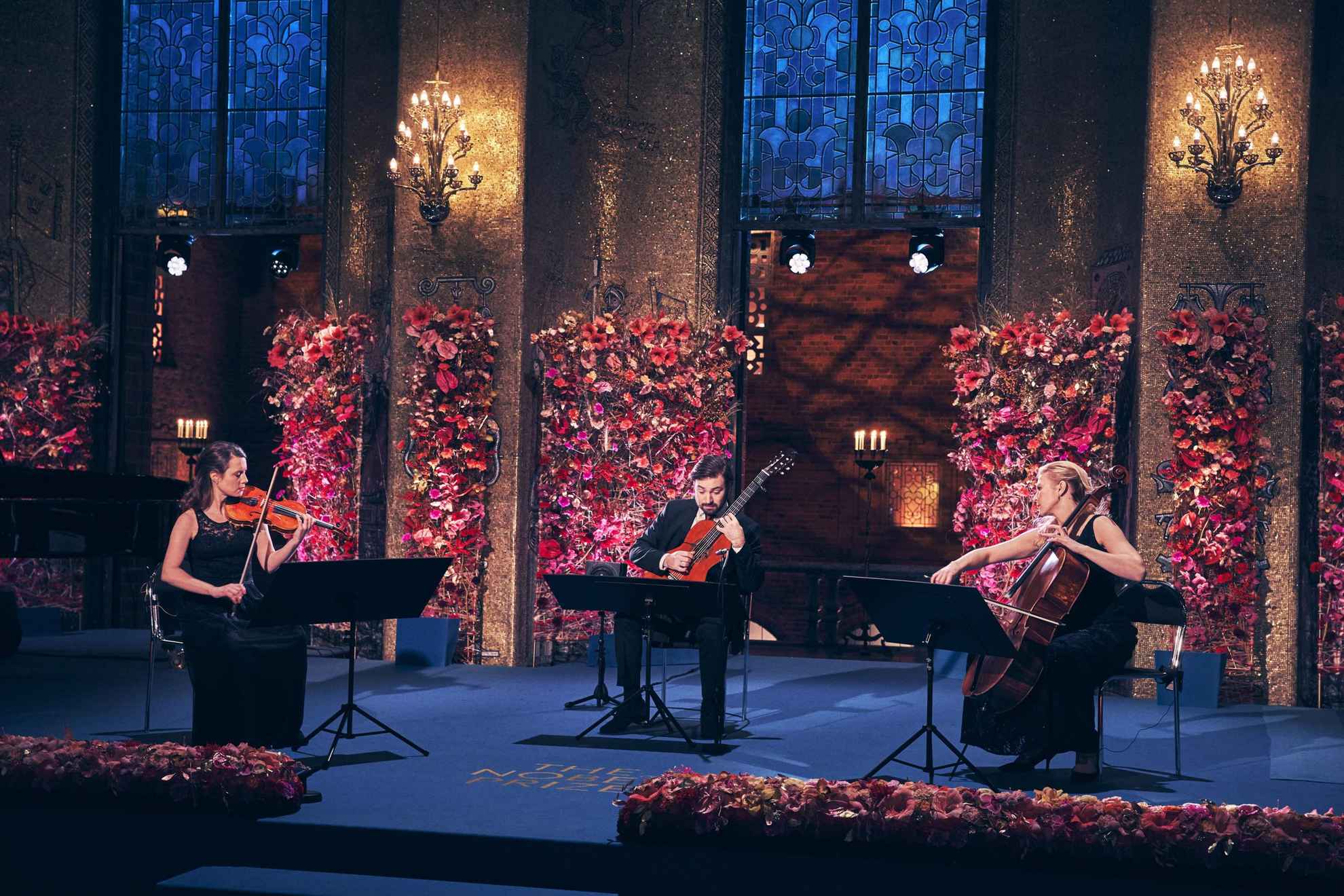 A guitarist, a cellist and a violinist performing at the Nobel Prize ceremony.