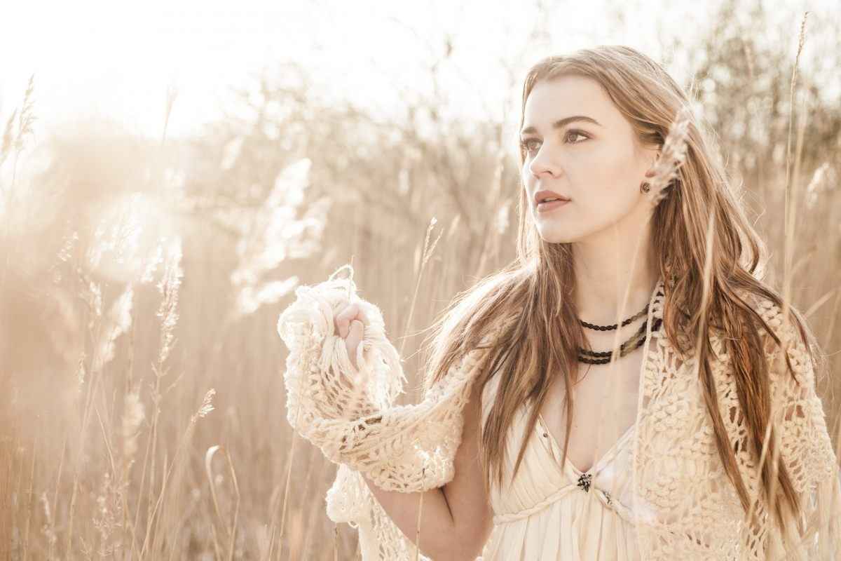 Singer Emmelie de Forest standing in a meadow