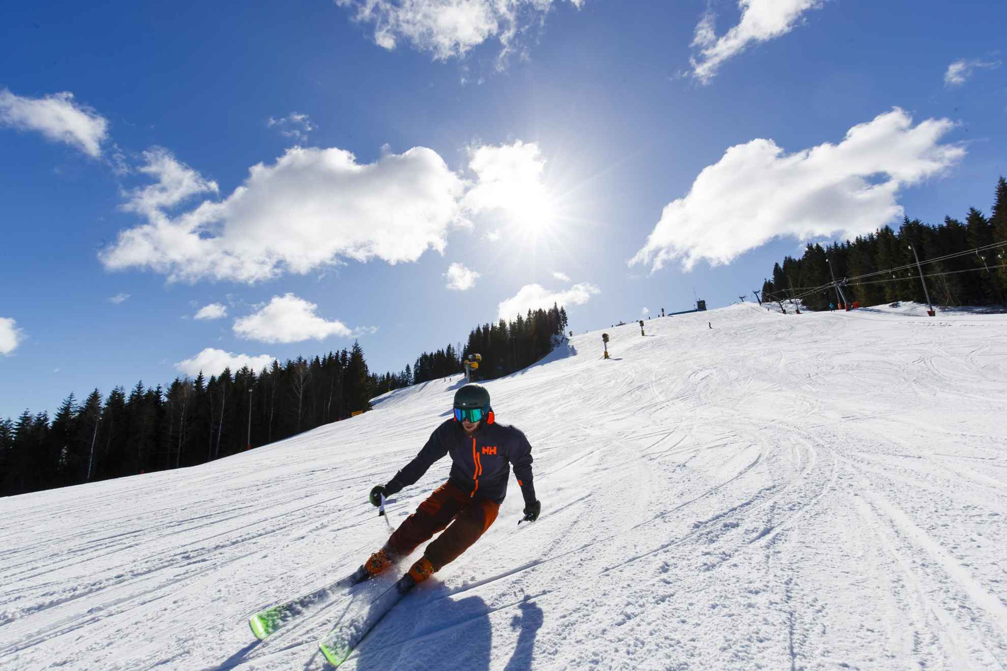 A person alpine skiing on a sunny winter day.