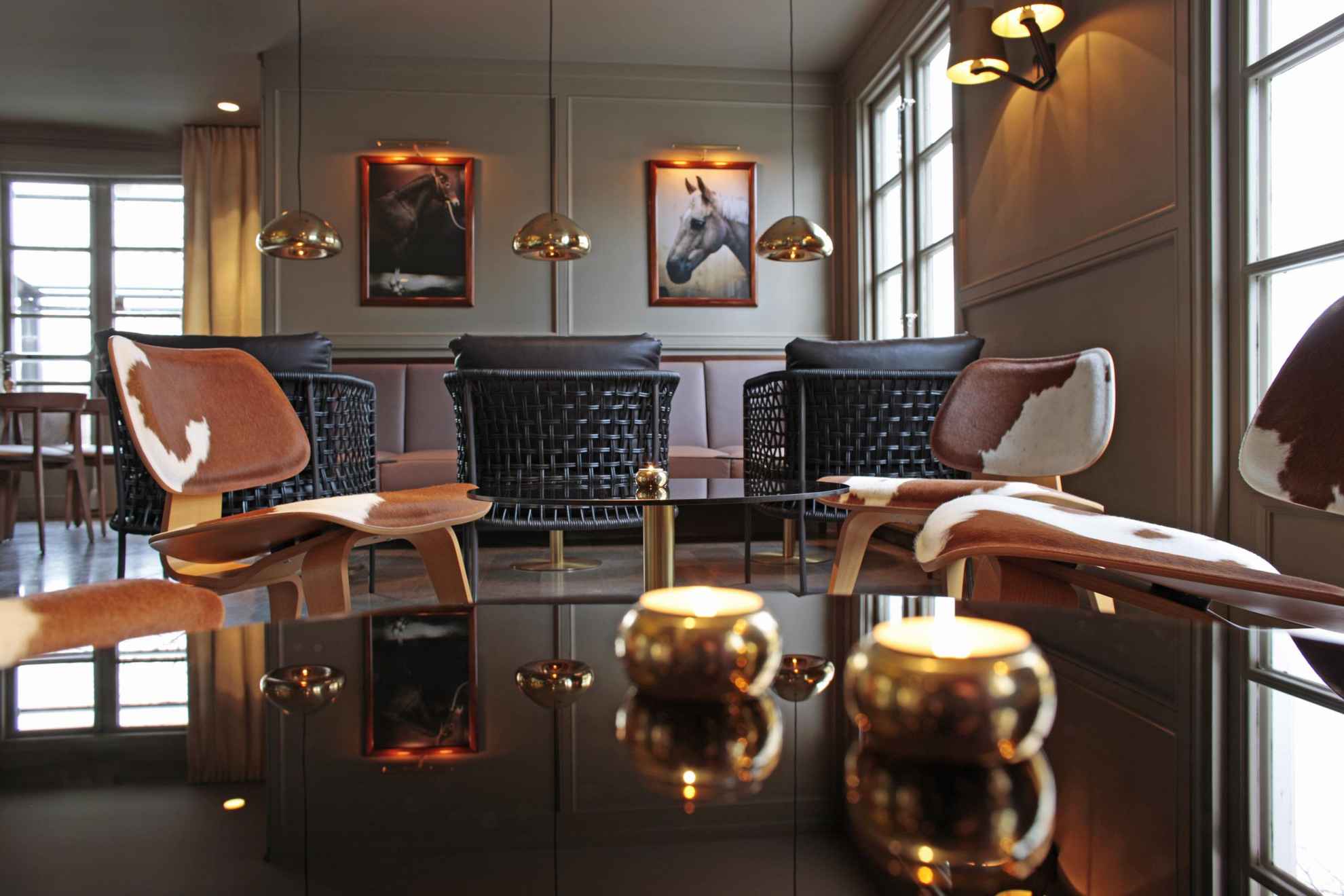 A lounge area in a hotel is decorated with furniture in warm copper tones.