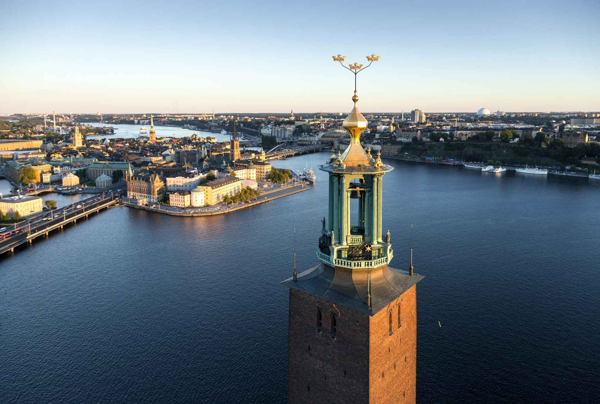 Aerial view of the Stockholm City Hall Tower on a sunny day. Stockholm's Old Town across the water, in the background.