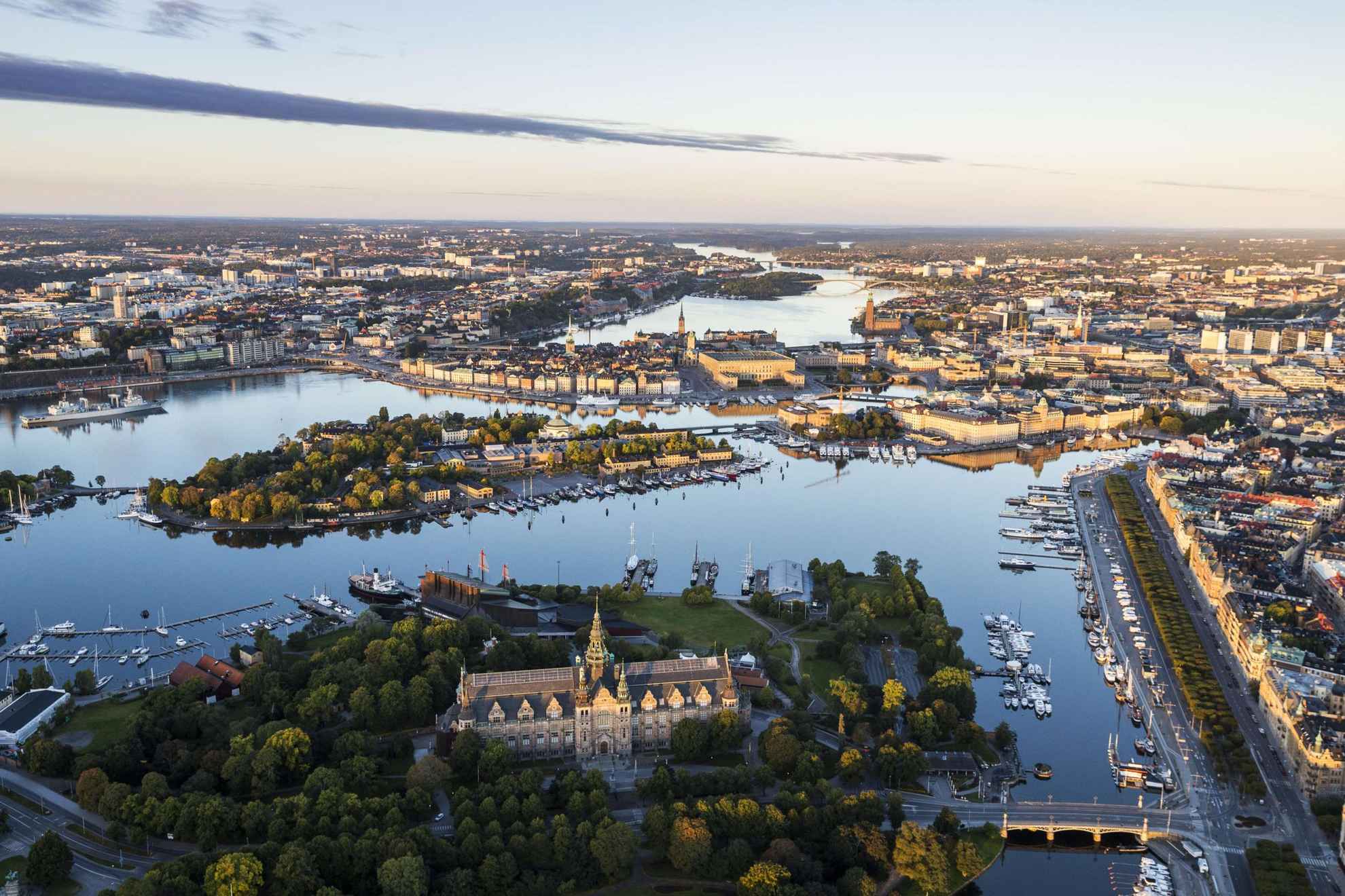 Aerial view of water all around the island of Djurgården and the boats along the quays.