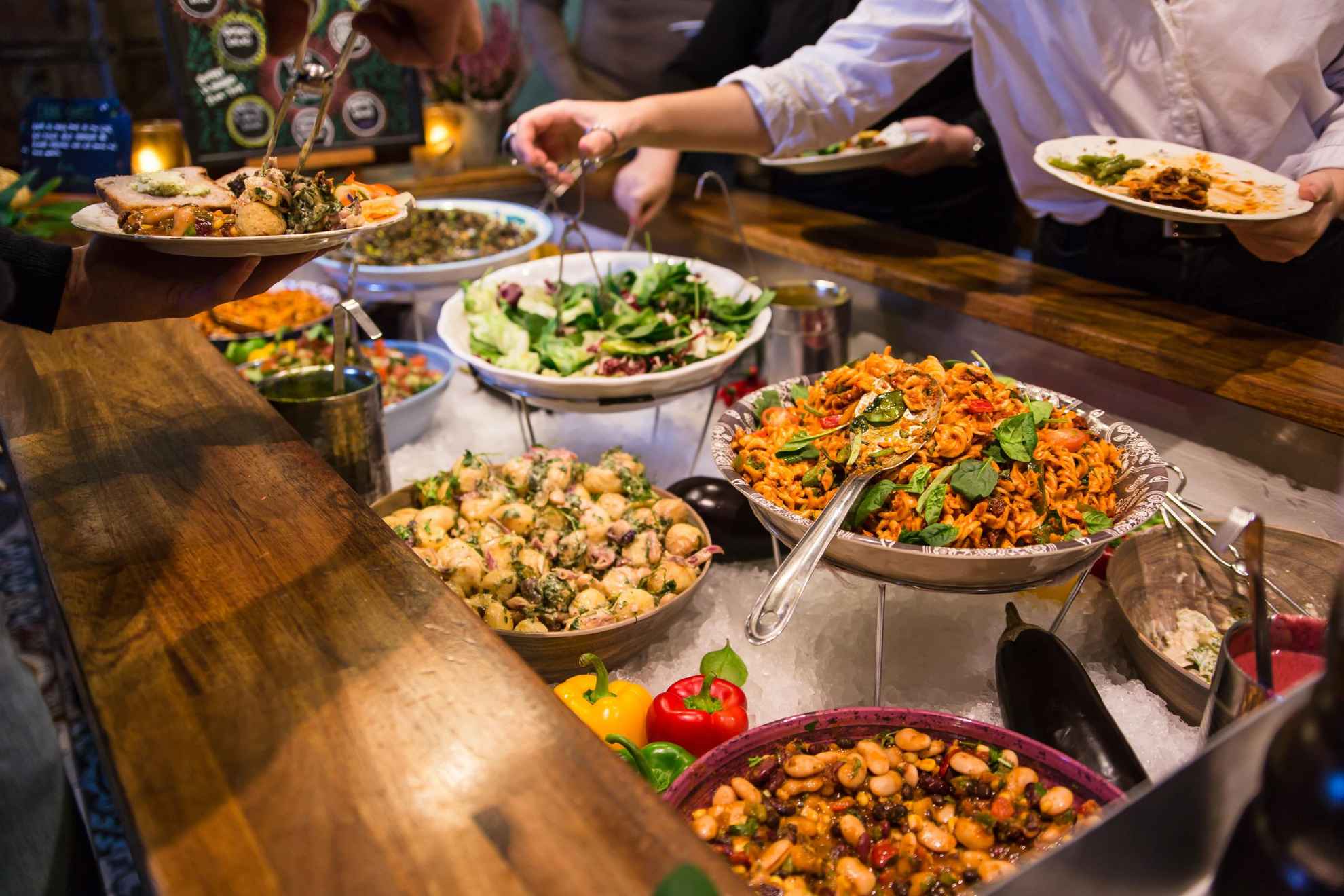 A buffet with bowls of vegan dishes.