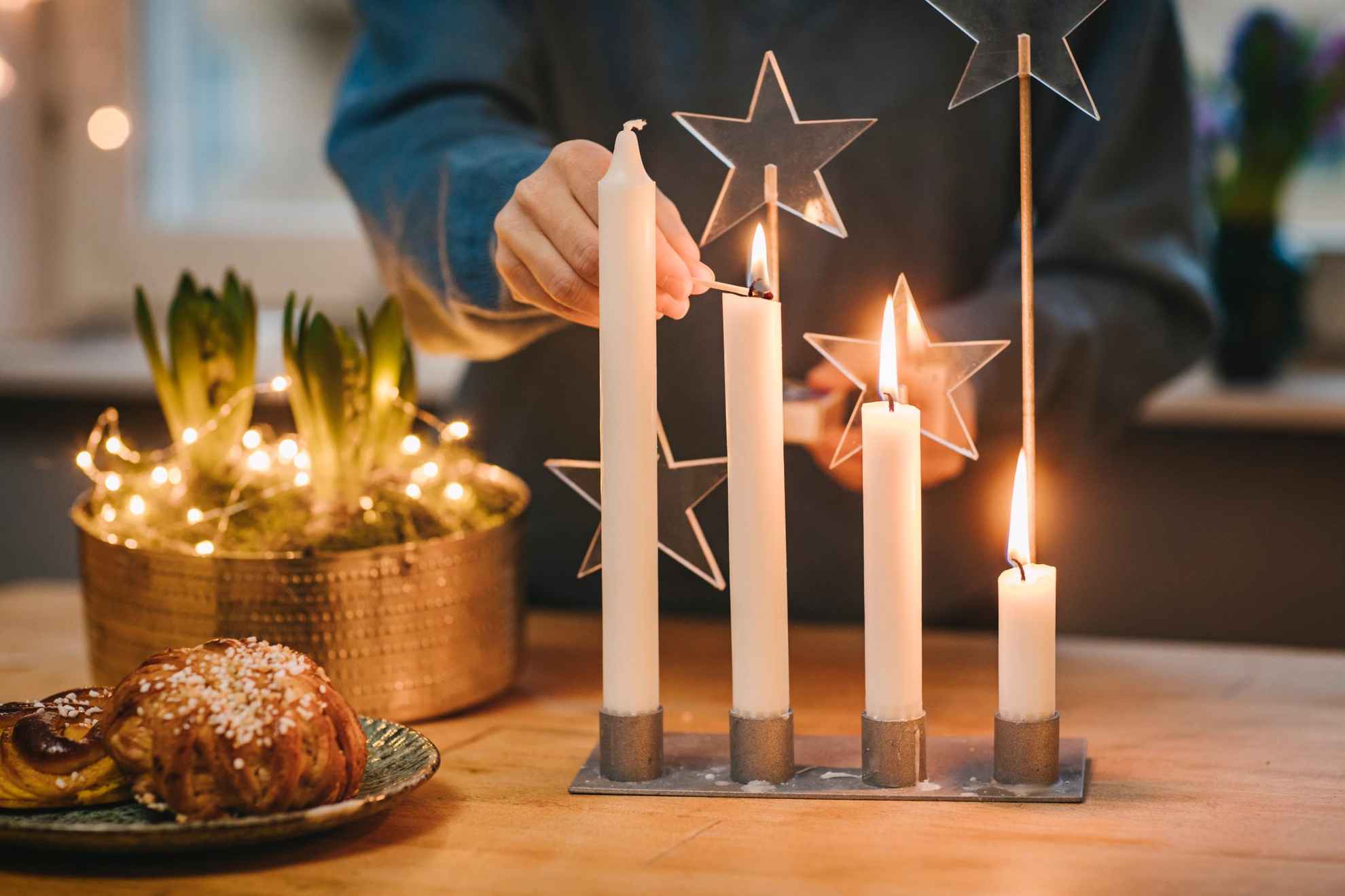 Person lighting candles for advent ahead of Christmas.