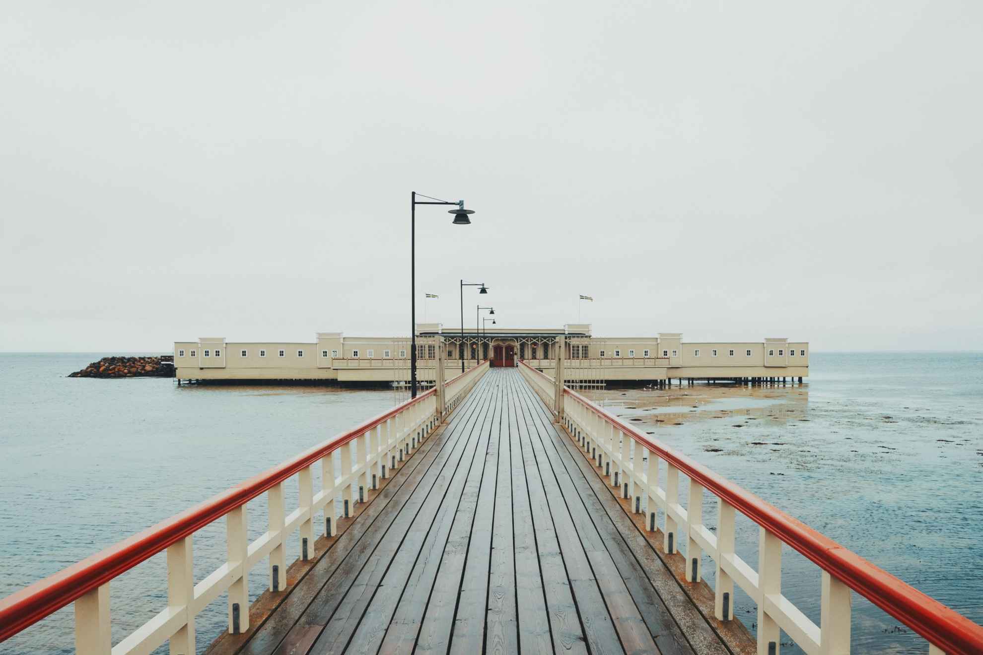 A long wooden pier leading out to a cold-water bath house in Malmö.