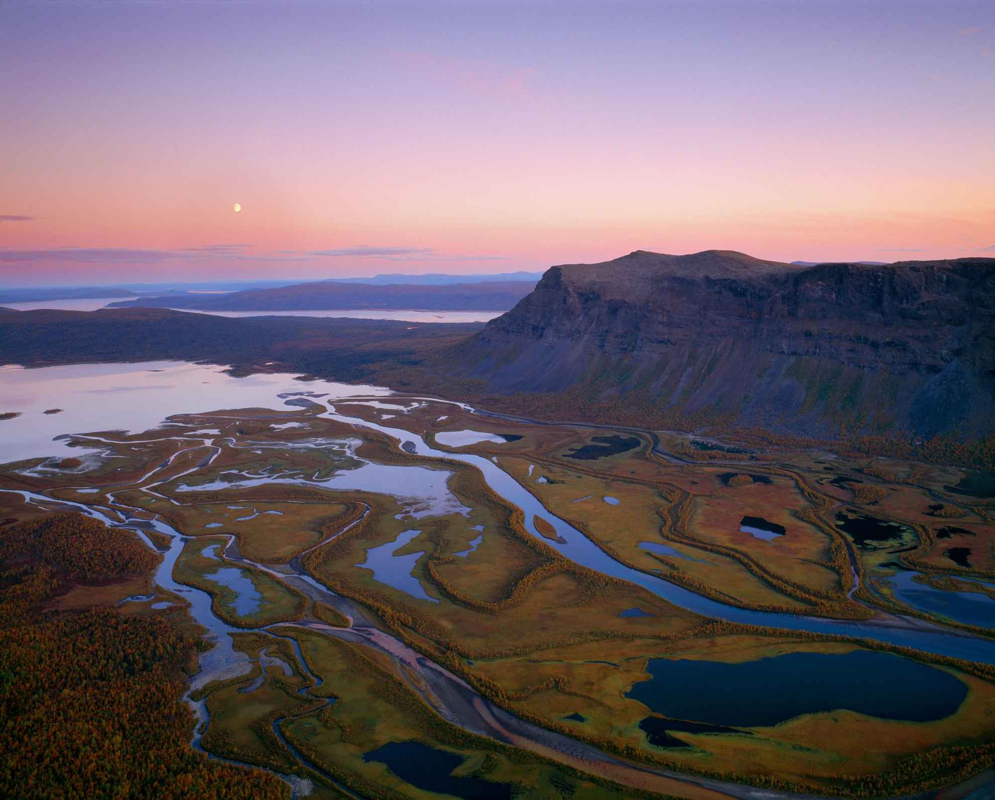Aerial view of Rapadalen valley and the surrounding mountains of Sarek National Park during twilight.