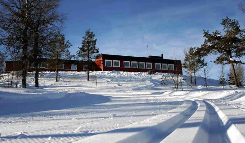 A cross-country skiing track in the snow outside Långberget Hostel.