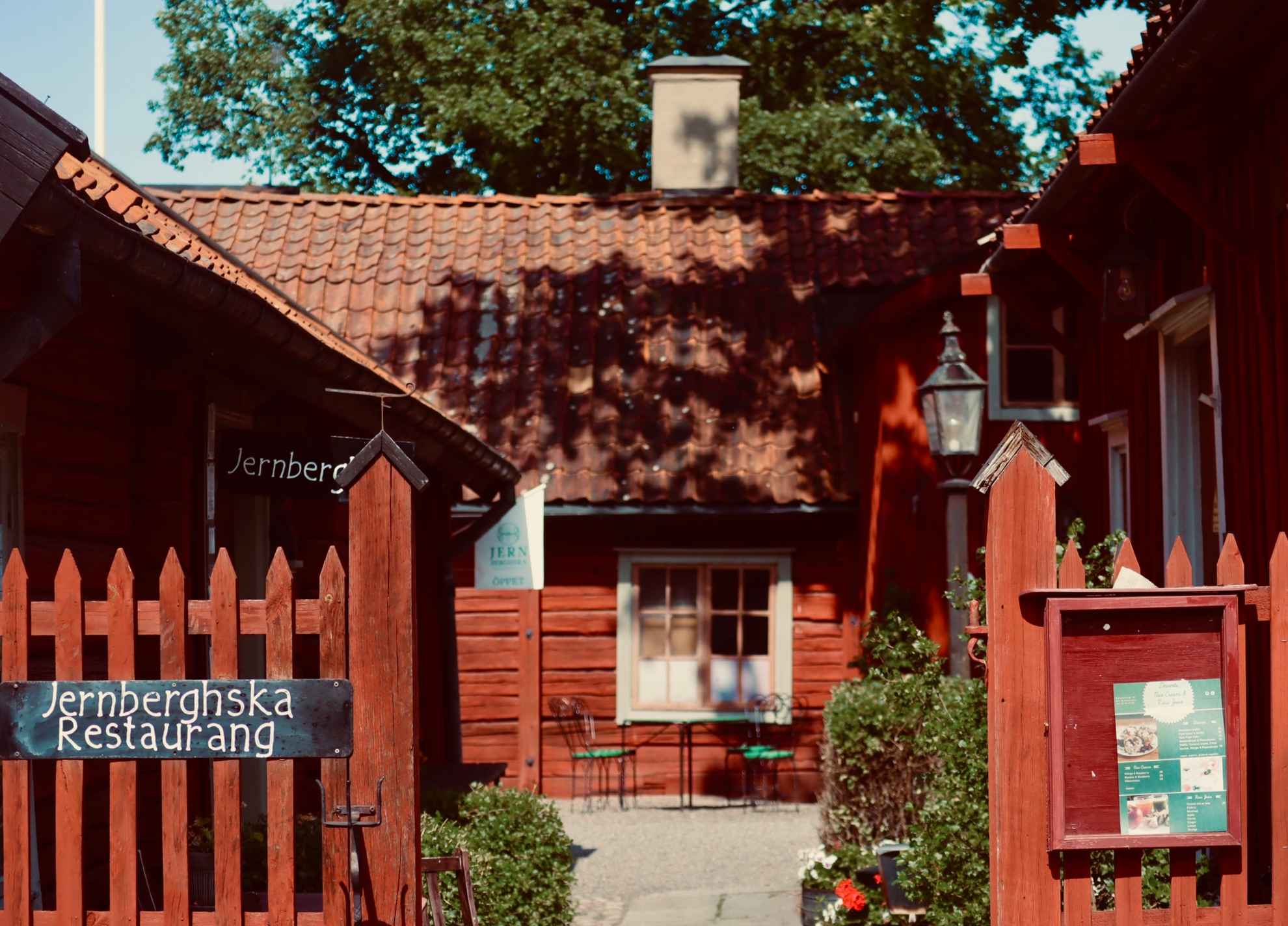 Red picket fences in front of red wooden houses at the open-air museum, Rademacher Forges, in Eskilstuna.