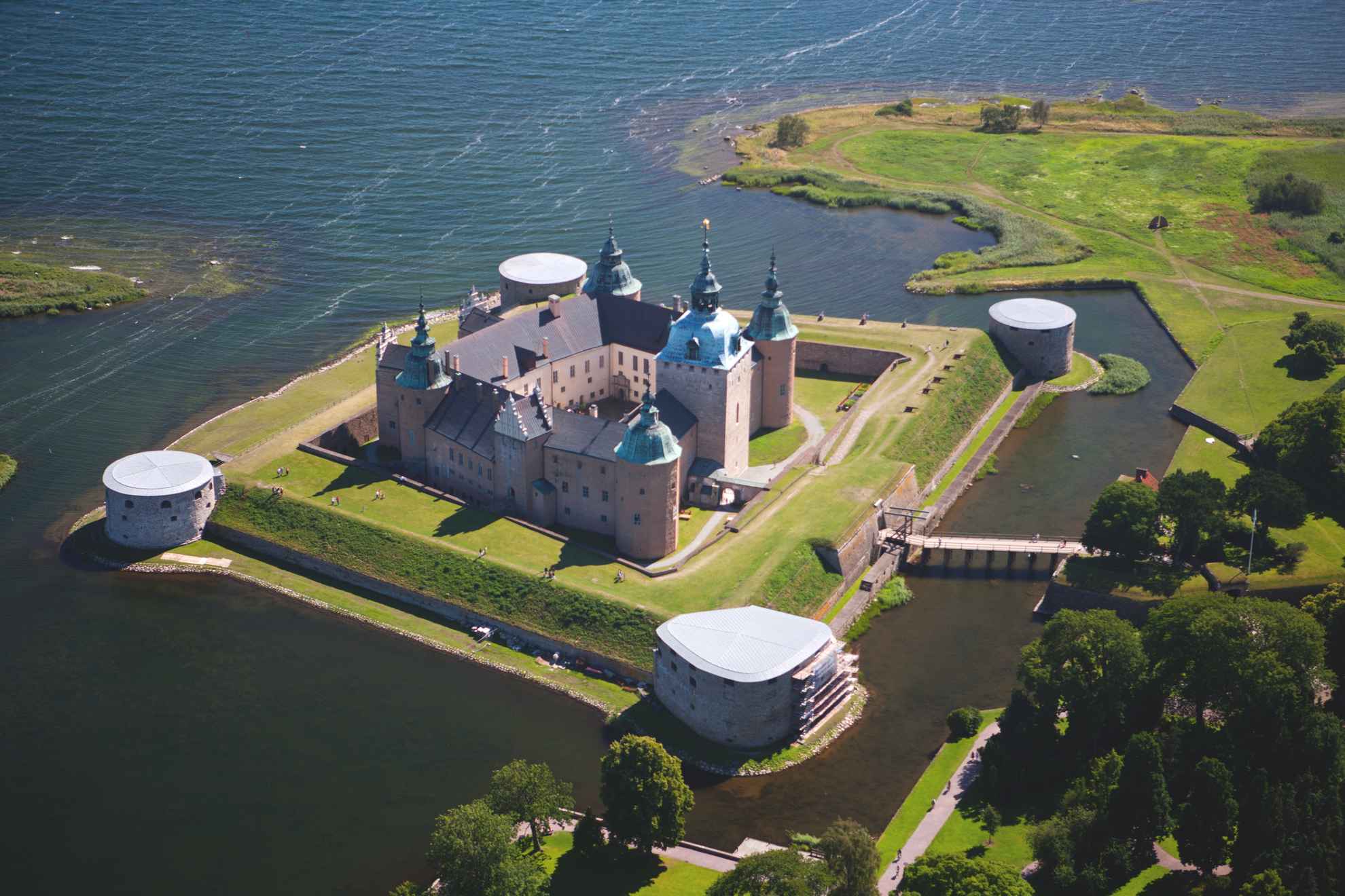 Aerial view of Kalmar Castle located on a small island surrounded by water with a small bridge to the mainland.