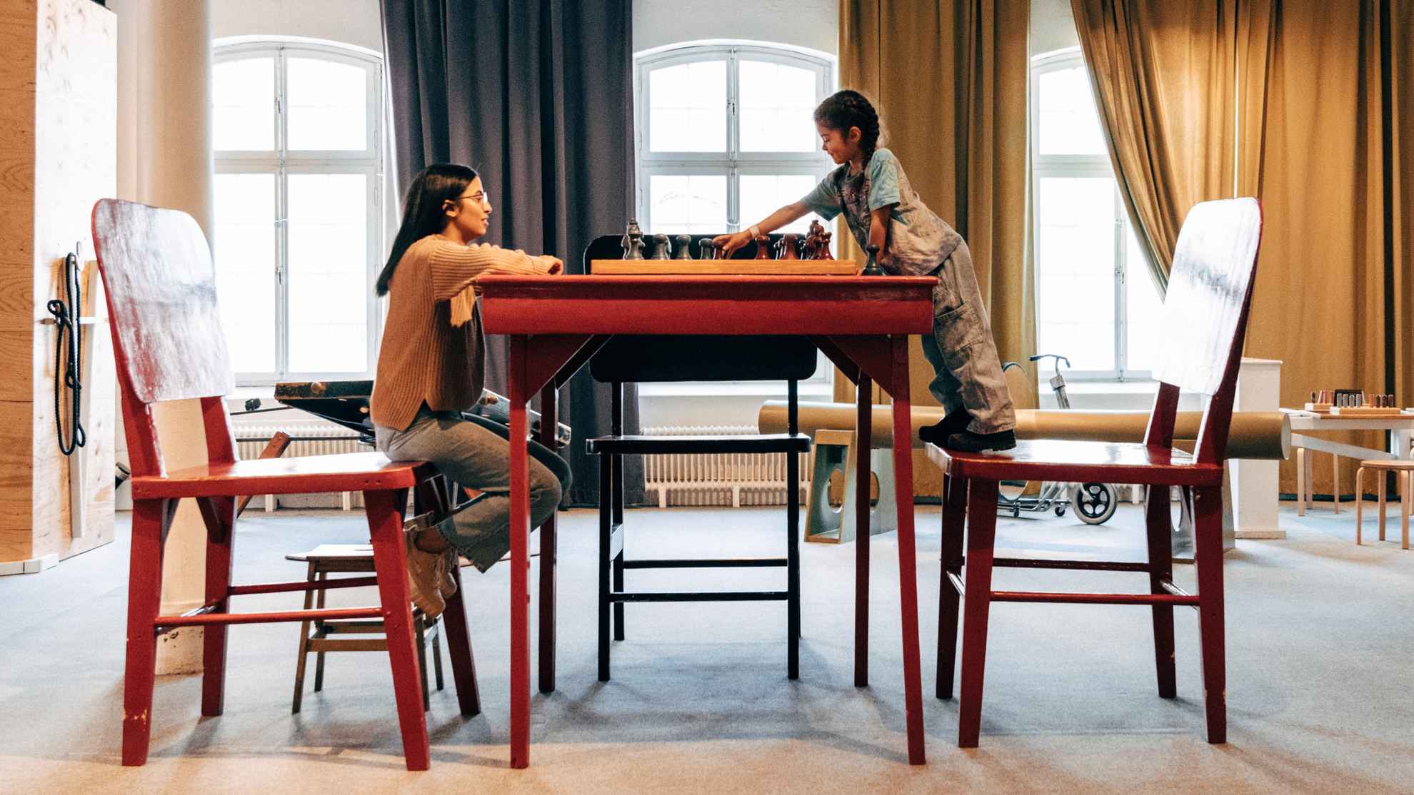 Woman and child playing chess at an enourmous table at Tom Tits