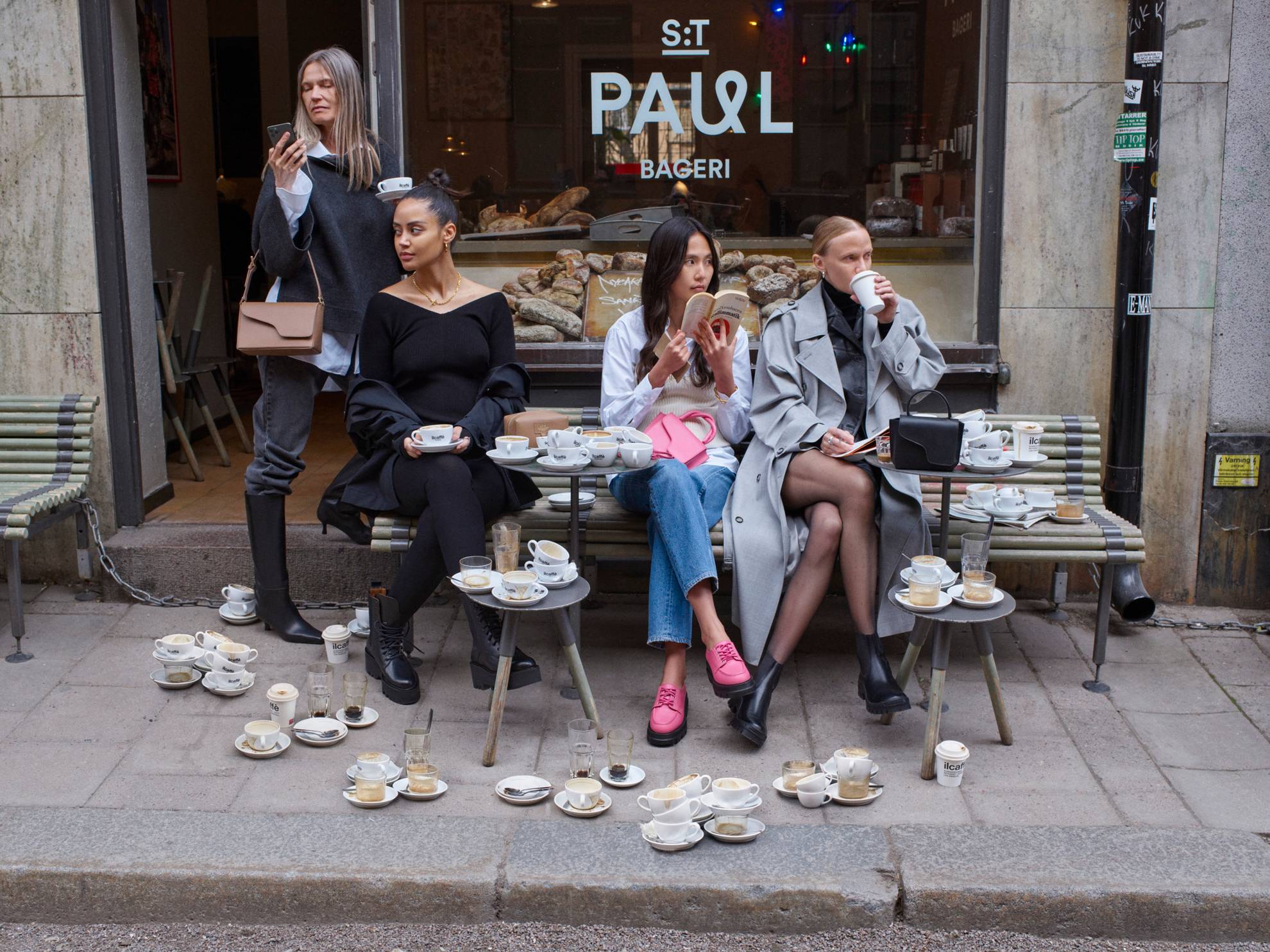 Models sit outside a café in Stockholm.