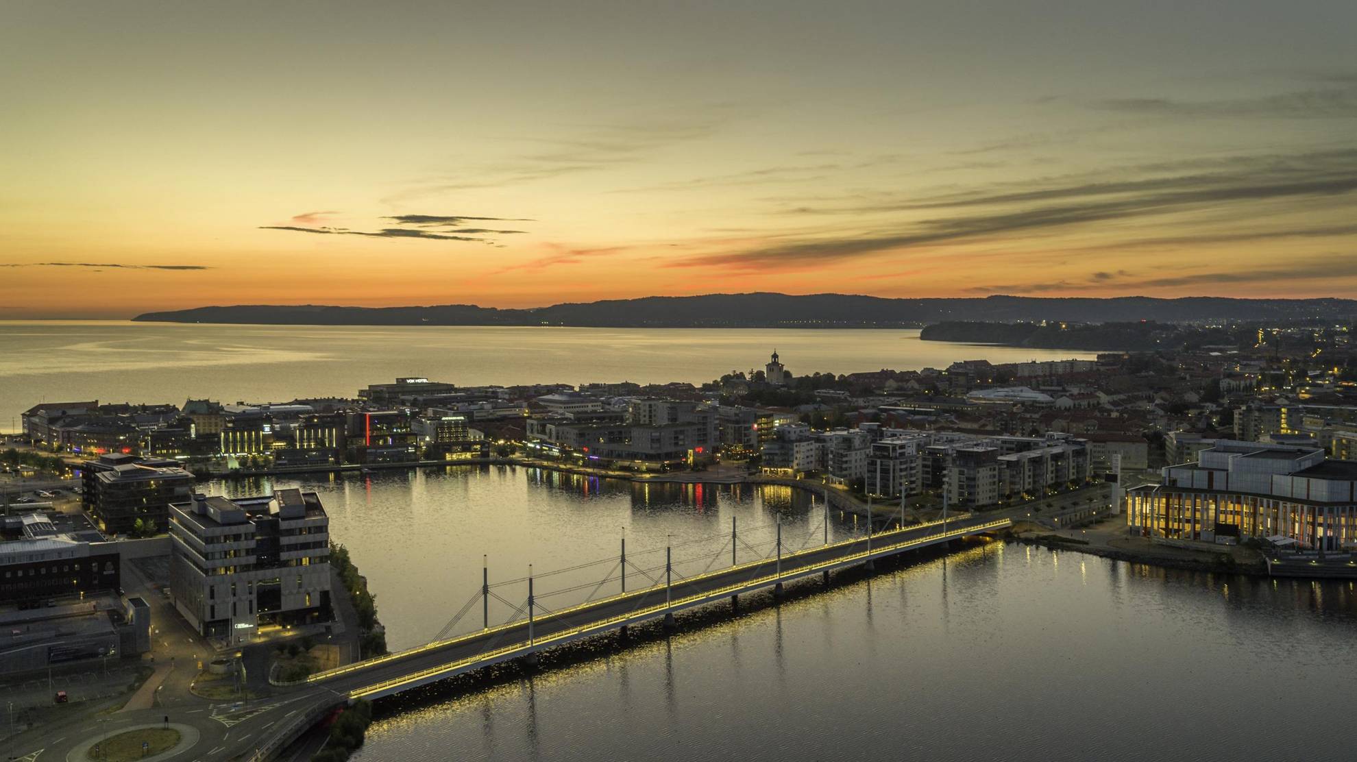 Aerial view over Jönköping city, and a lake, as the sun is setting.