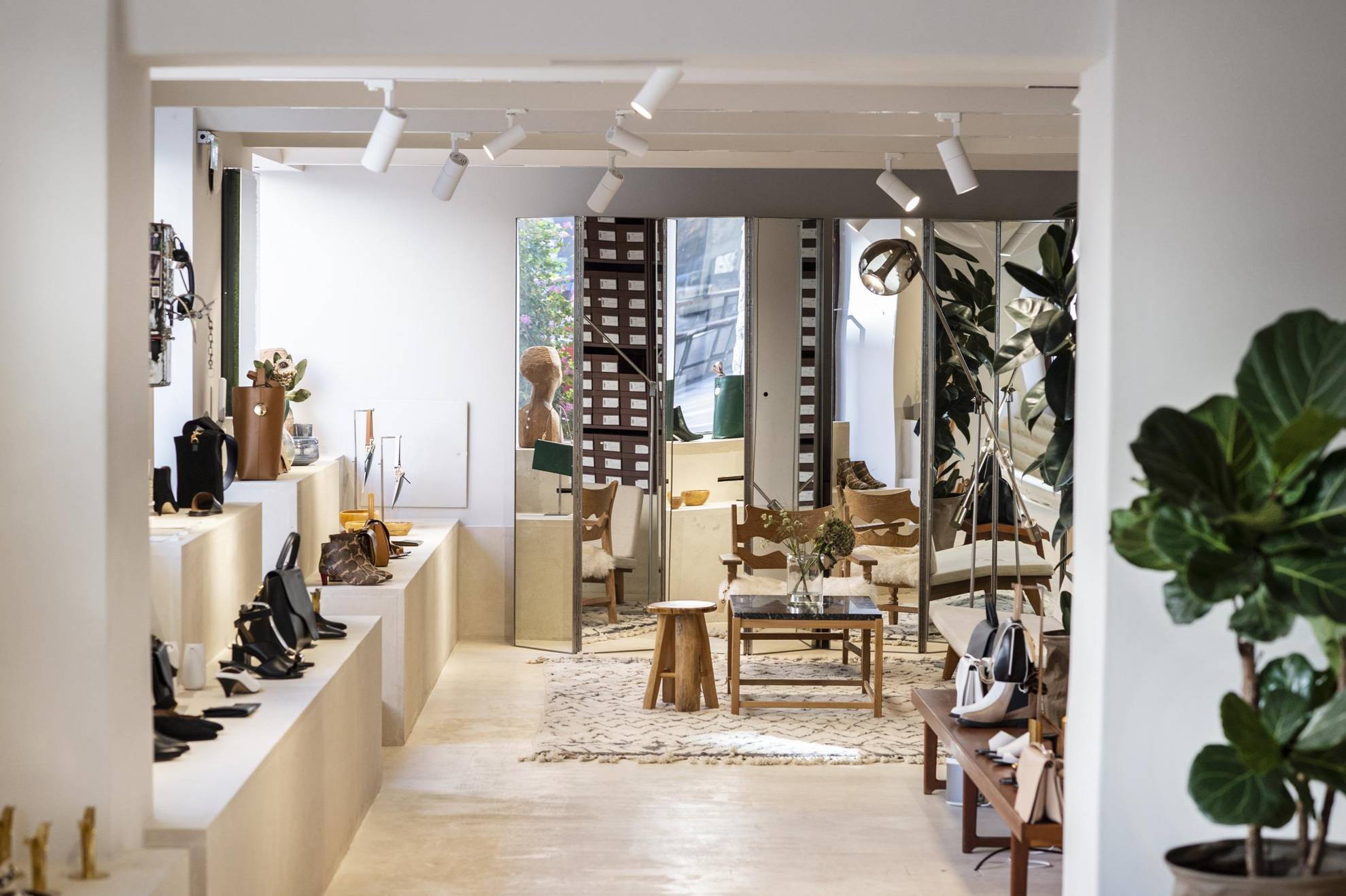 The bright interior of ATP atelier, with large windows by one wall, and footwear and accessory on display.