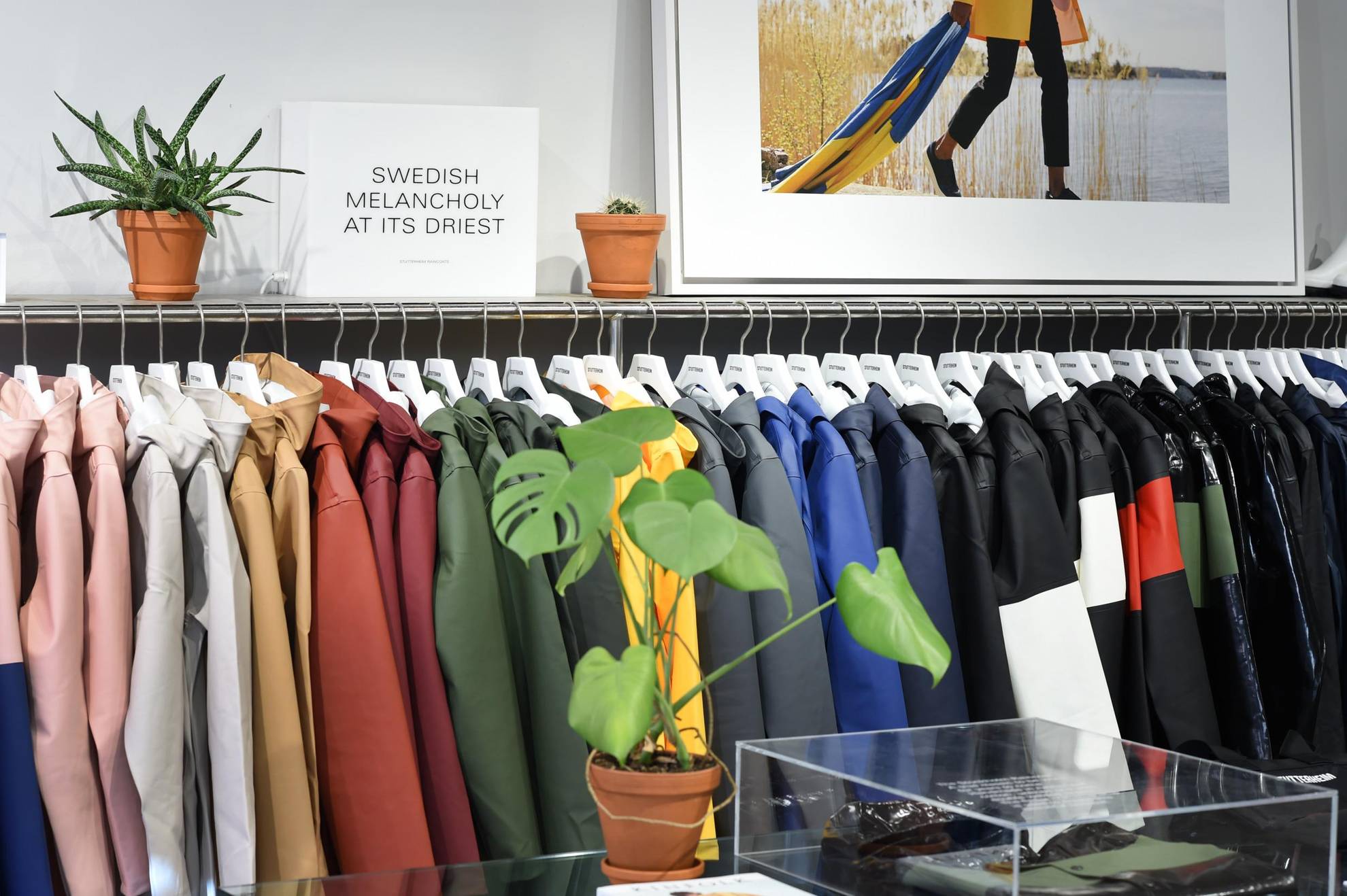 Colourful raincoats lined up at a Stutterheim shop in Stockholm.