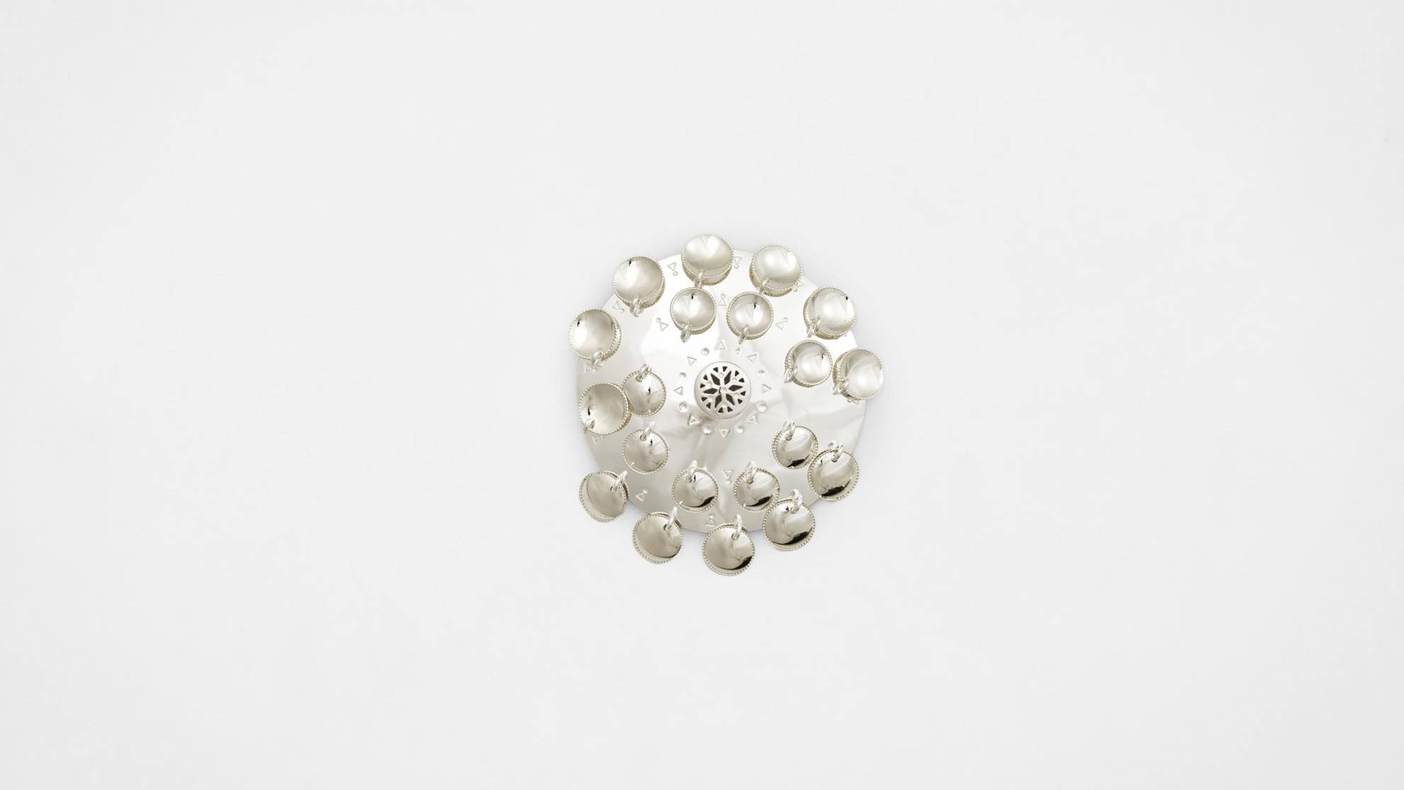 A brooch on a white surface.