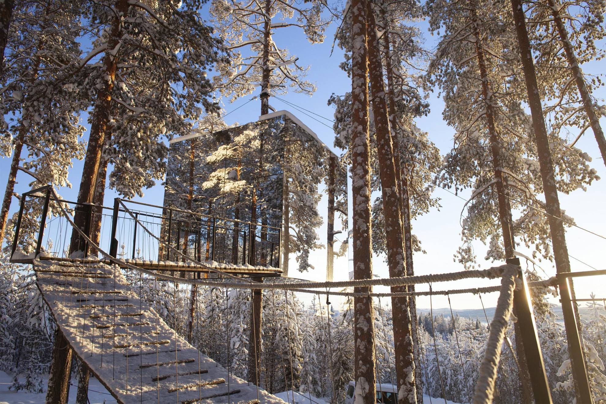 The tree hotel made of mirror glass, set in a snowy forest in Swedish Lapland.