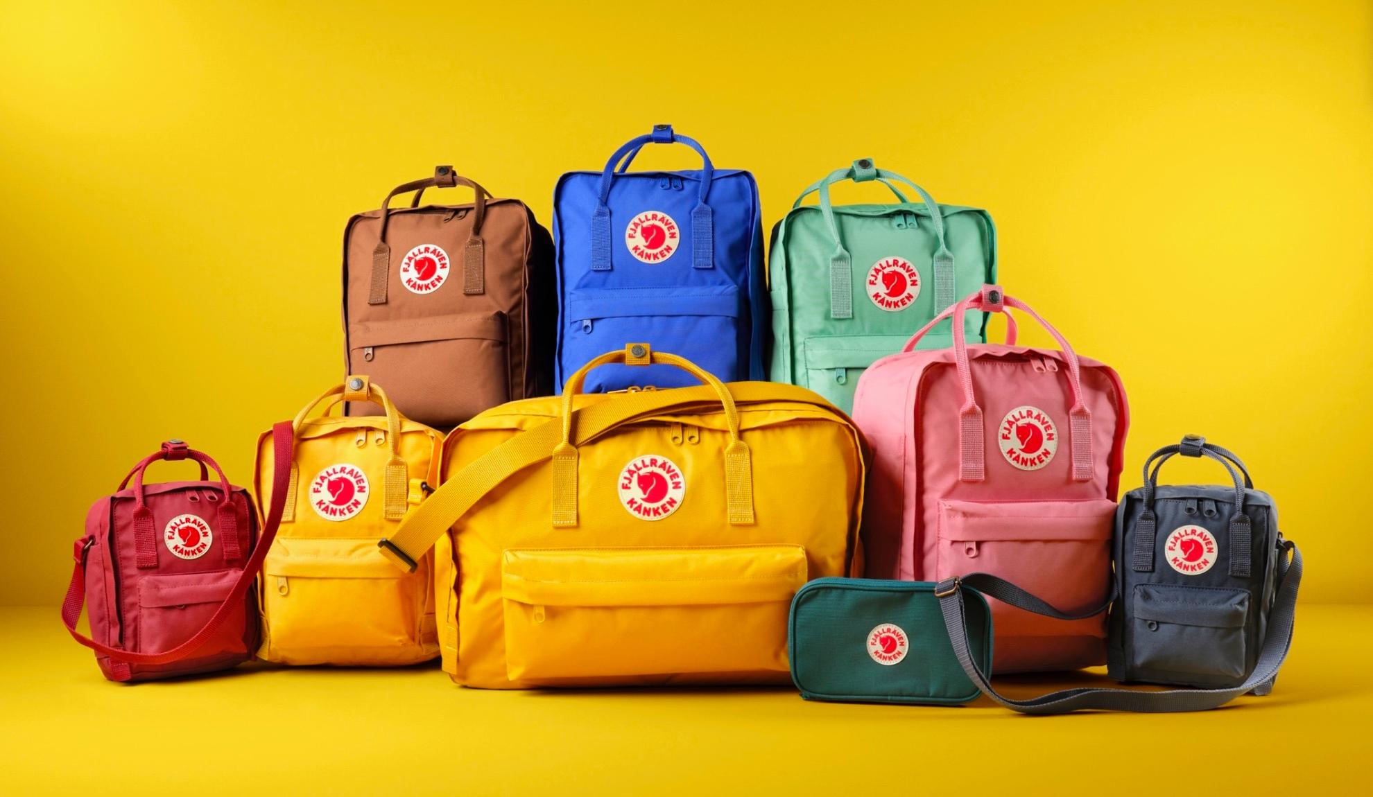 Several backpacks from Fjällräven on a yellow background.