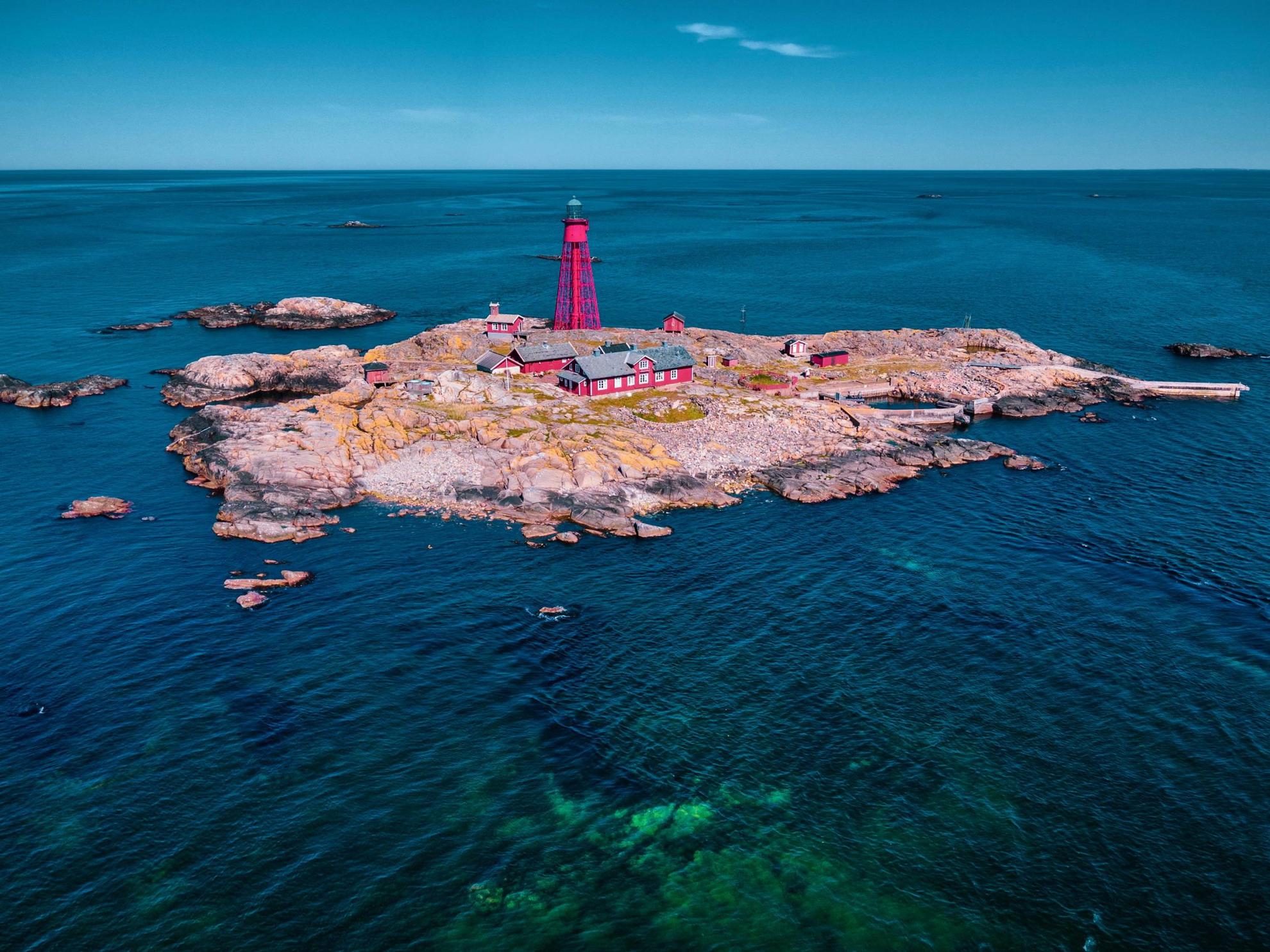 Aerial view of houses and a lighthouse on an small island in the archipelago.